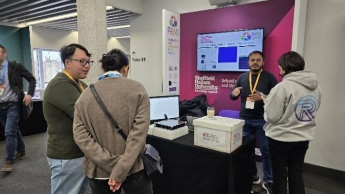 People discussing around a pop-up stand