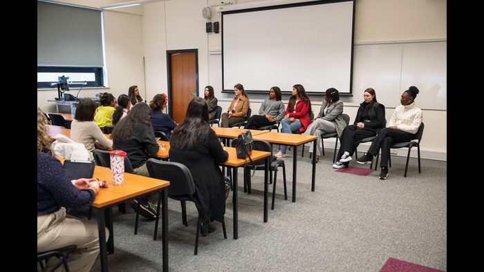 Classroom of participants engaging with a panel discussion
