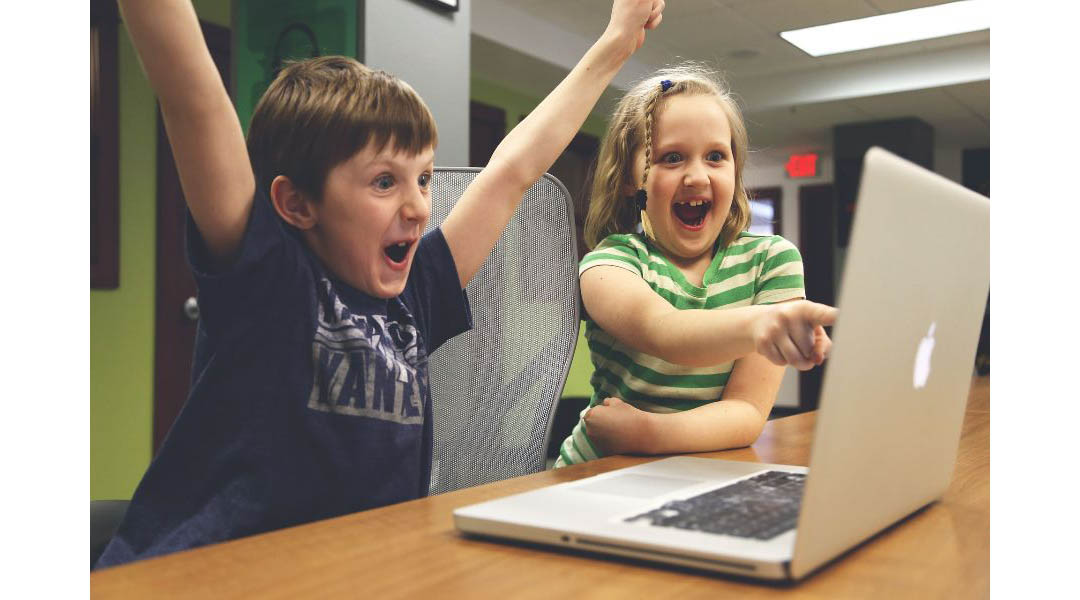Children excited at computer