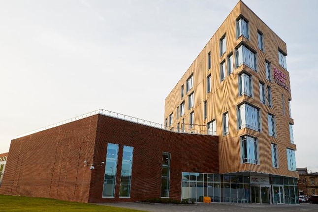 Image shows a wide shot of the outside of the Advanced Wellbeing Research Centre