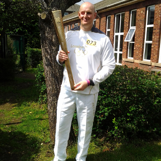 Dan Porter holding Olympic torch