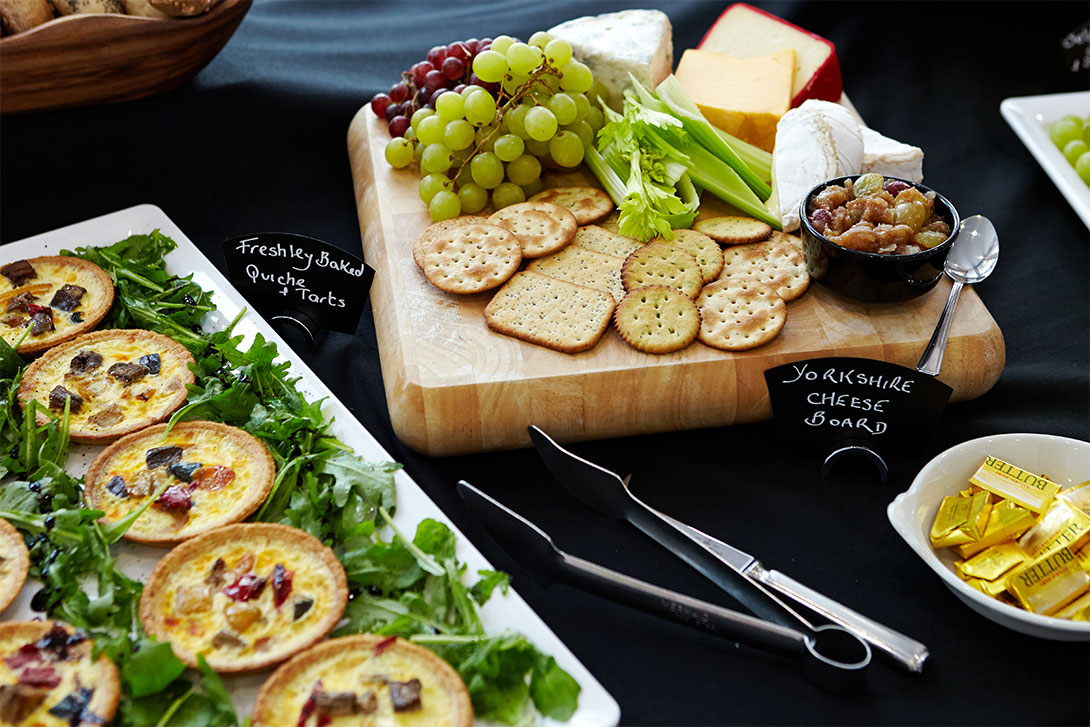 Selection of pastries, cheeses, and biscuits