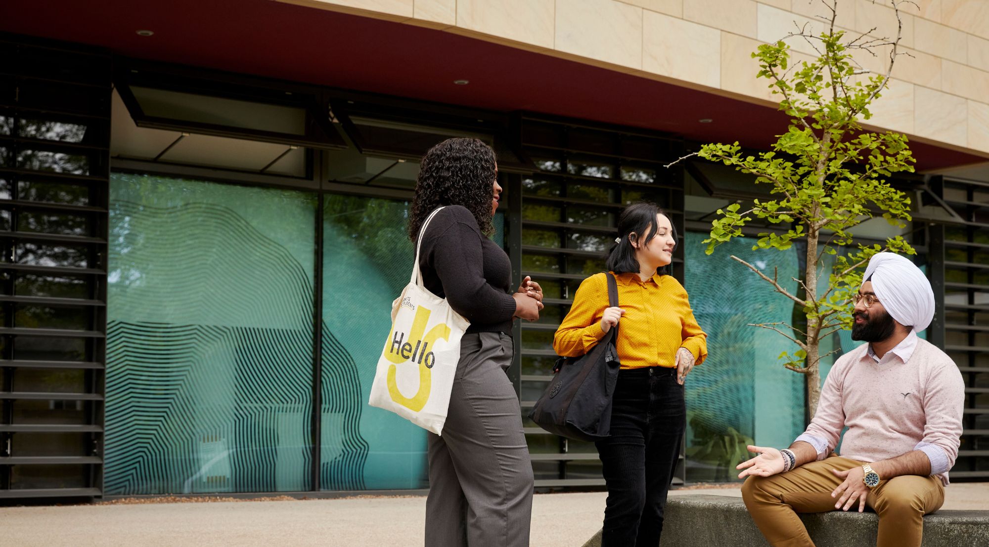 Three students outside on Collegiate Campus