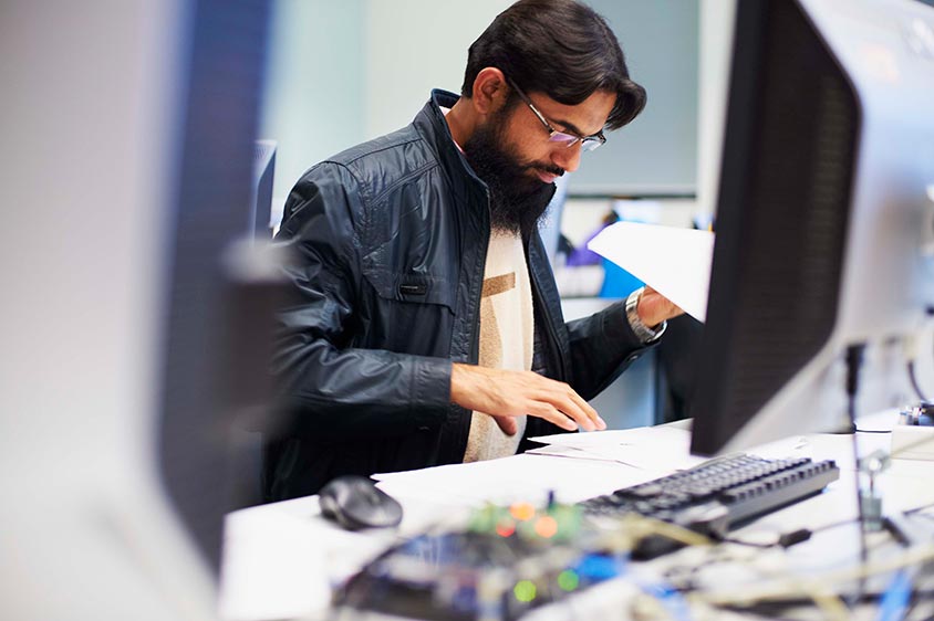 A man working next to a computer