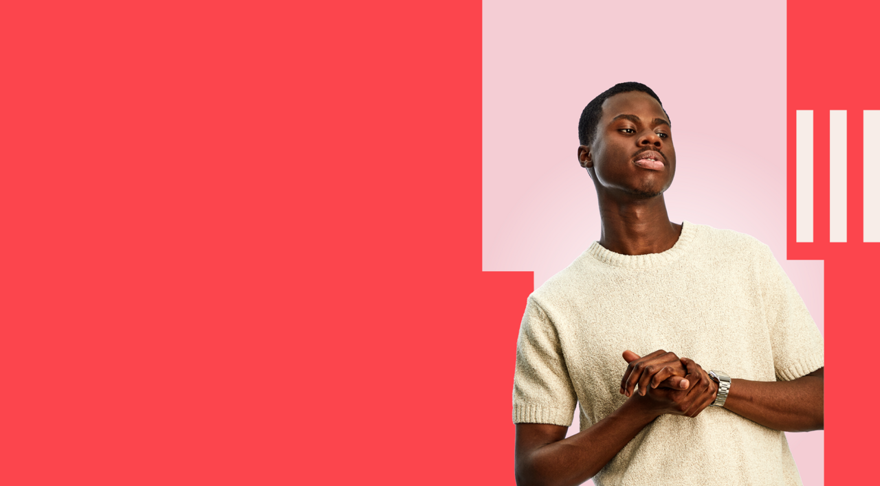 Marketing student stood confidently, wearing a cream t-shirt.