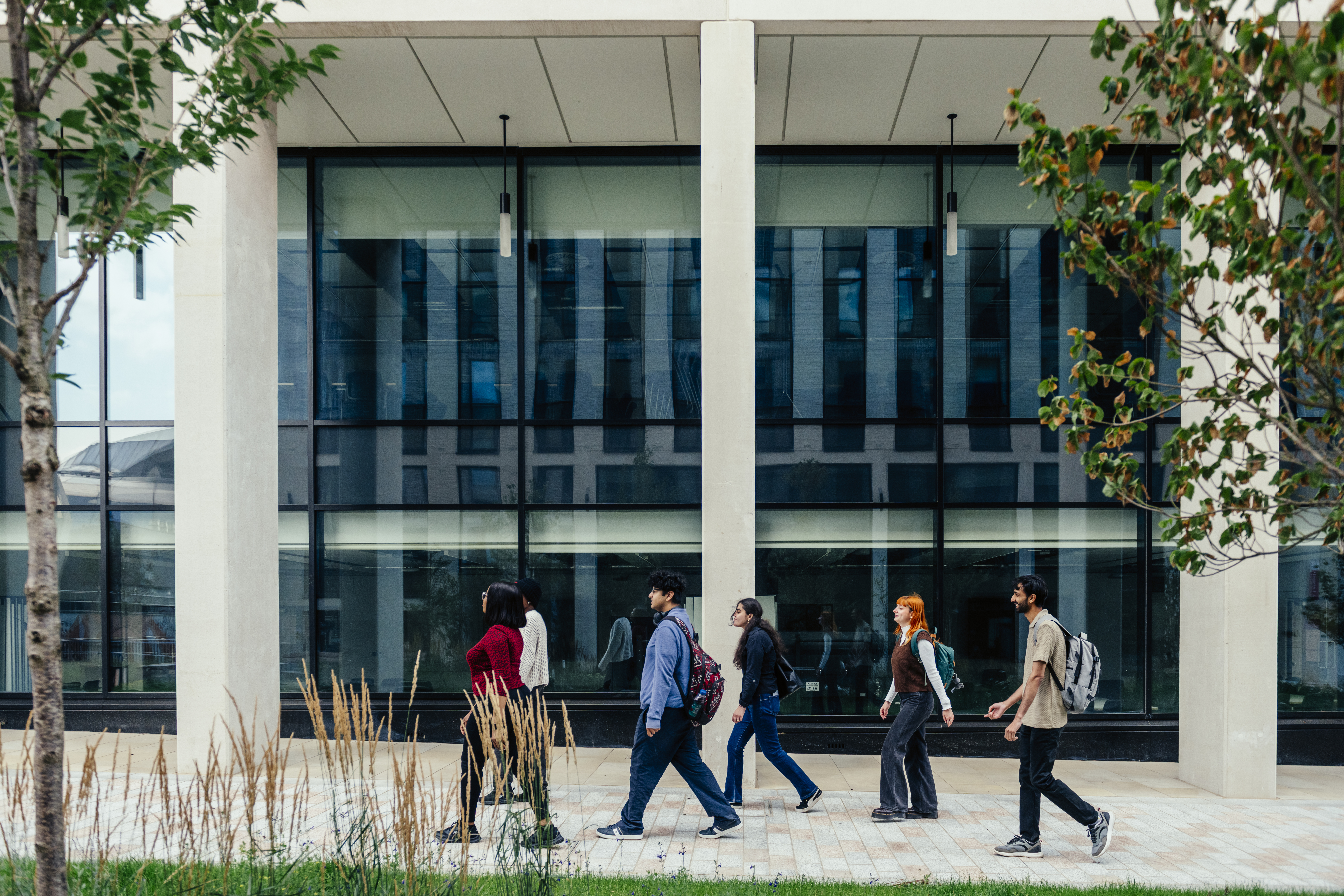 Marketing students walking outside the business school.