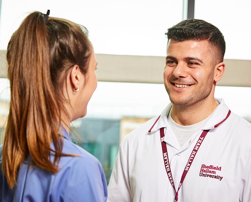 a female and male student nurses talking