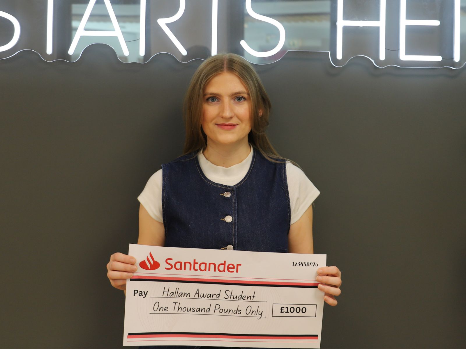 Student holding large cheque