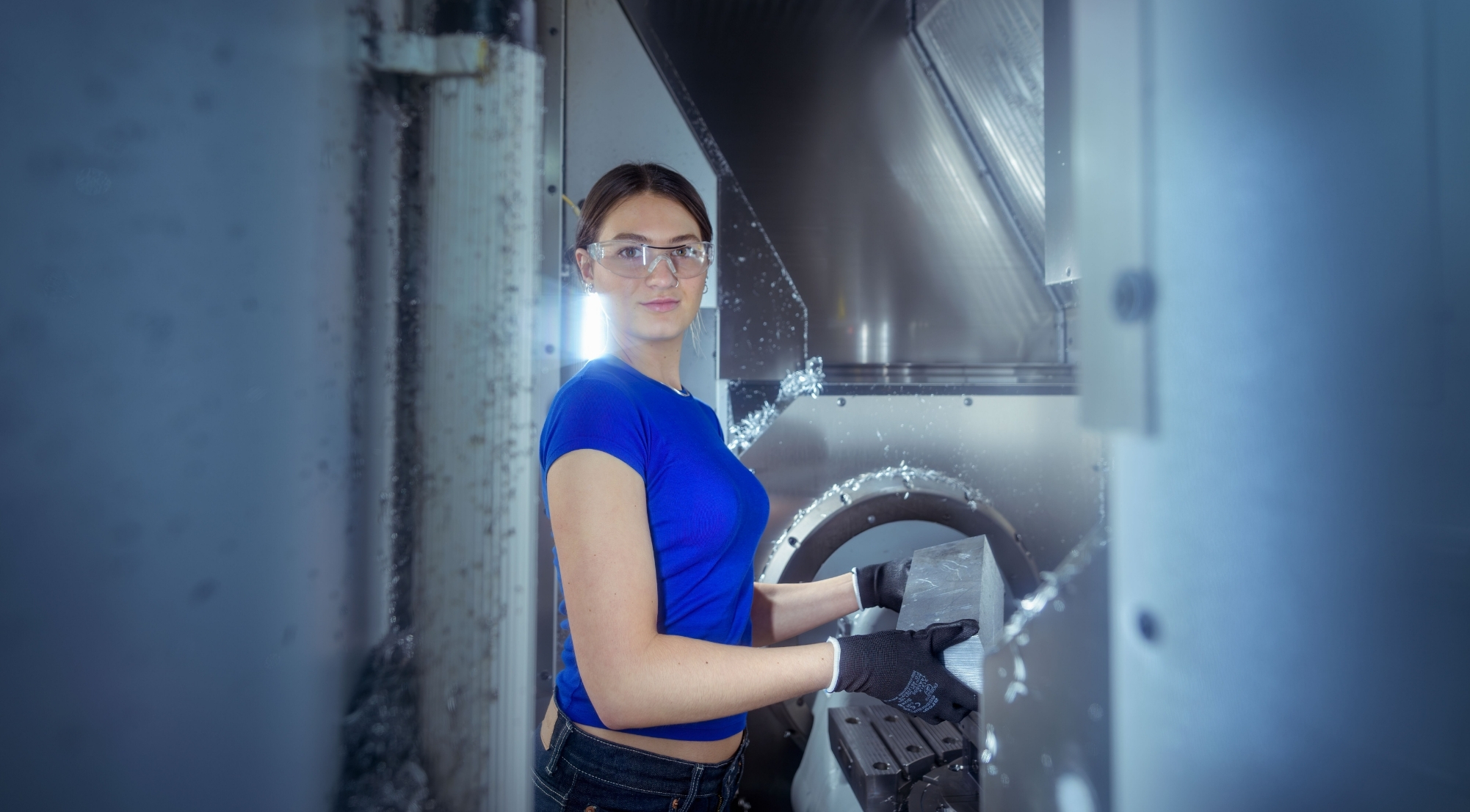 Female student stood working with engineering equipment