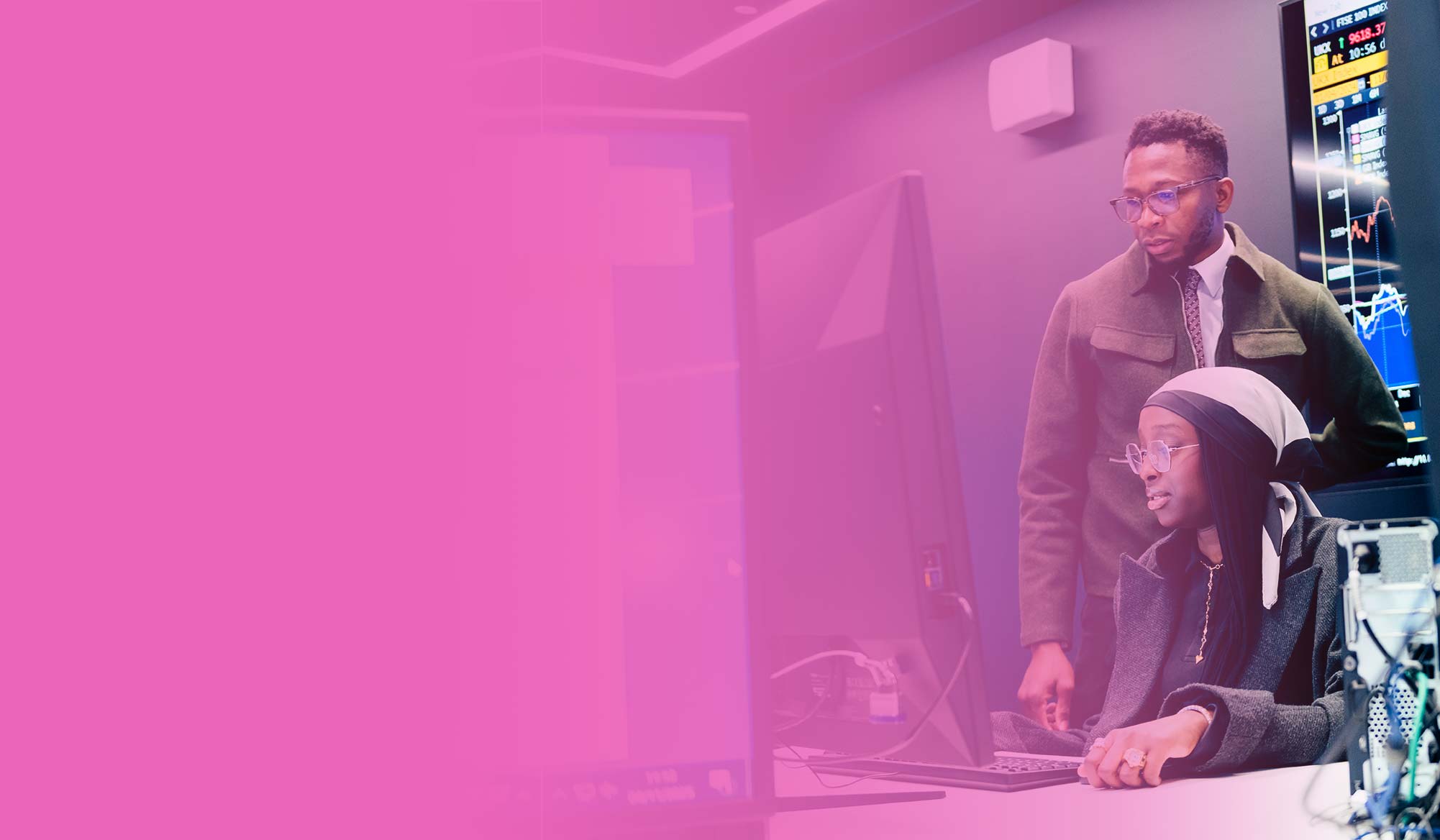 Accounting student sat at computer with an academic, against a pink gradient background