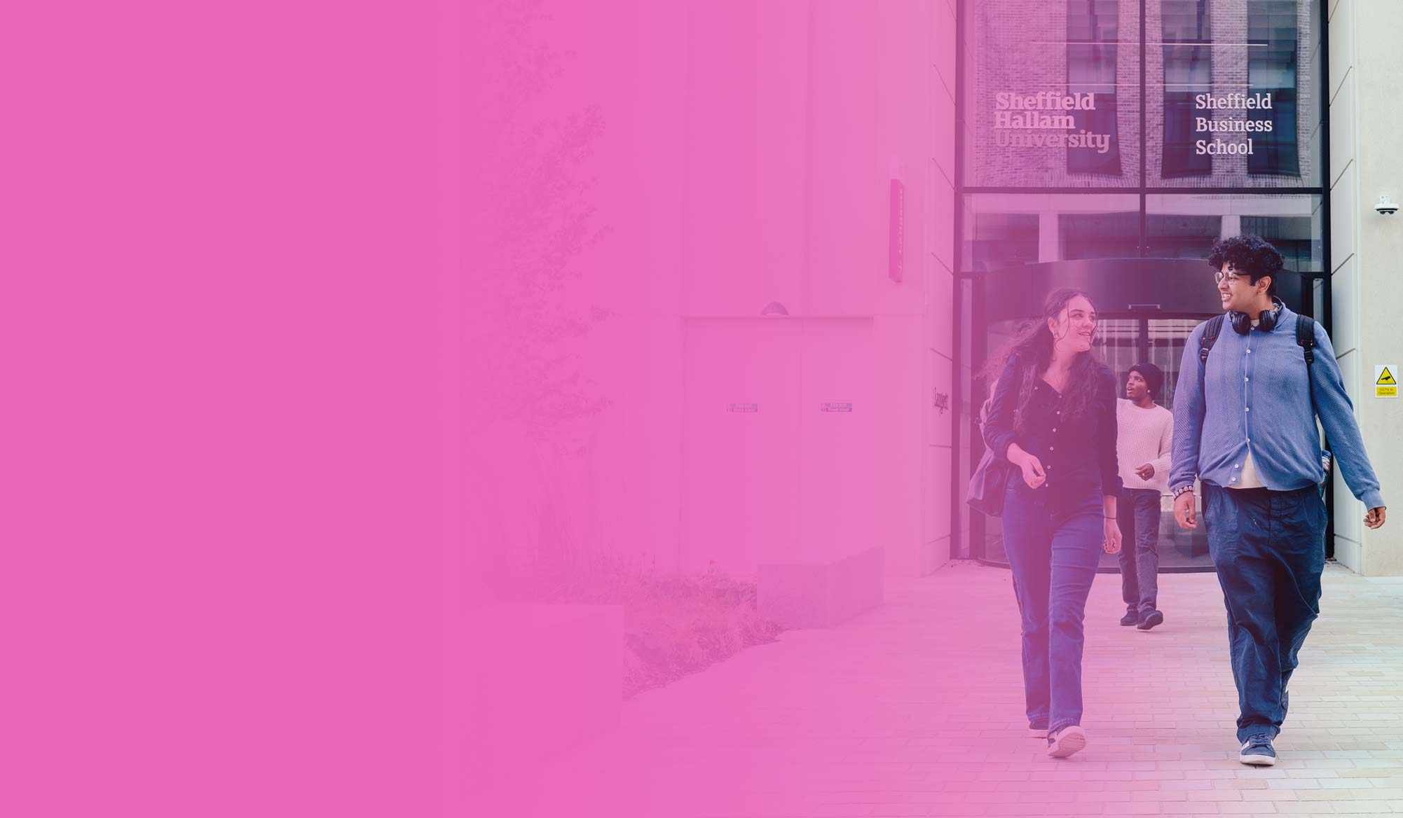 Two students leaving the business school chatting, against a pink gradient background