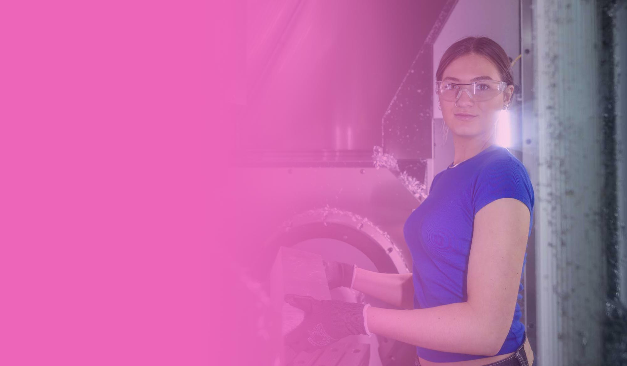 Female student stood working with engineering equipment, against a pink gradient background