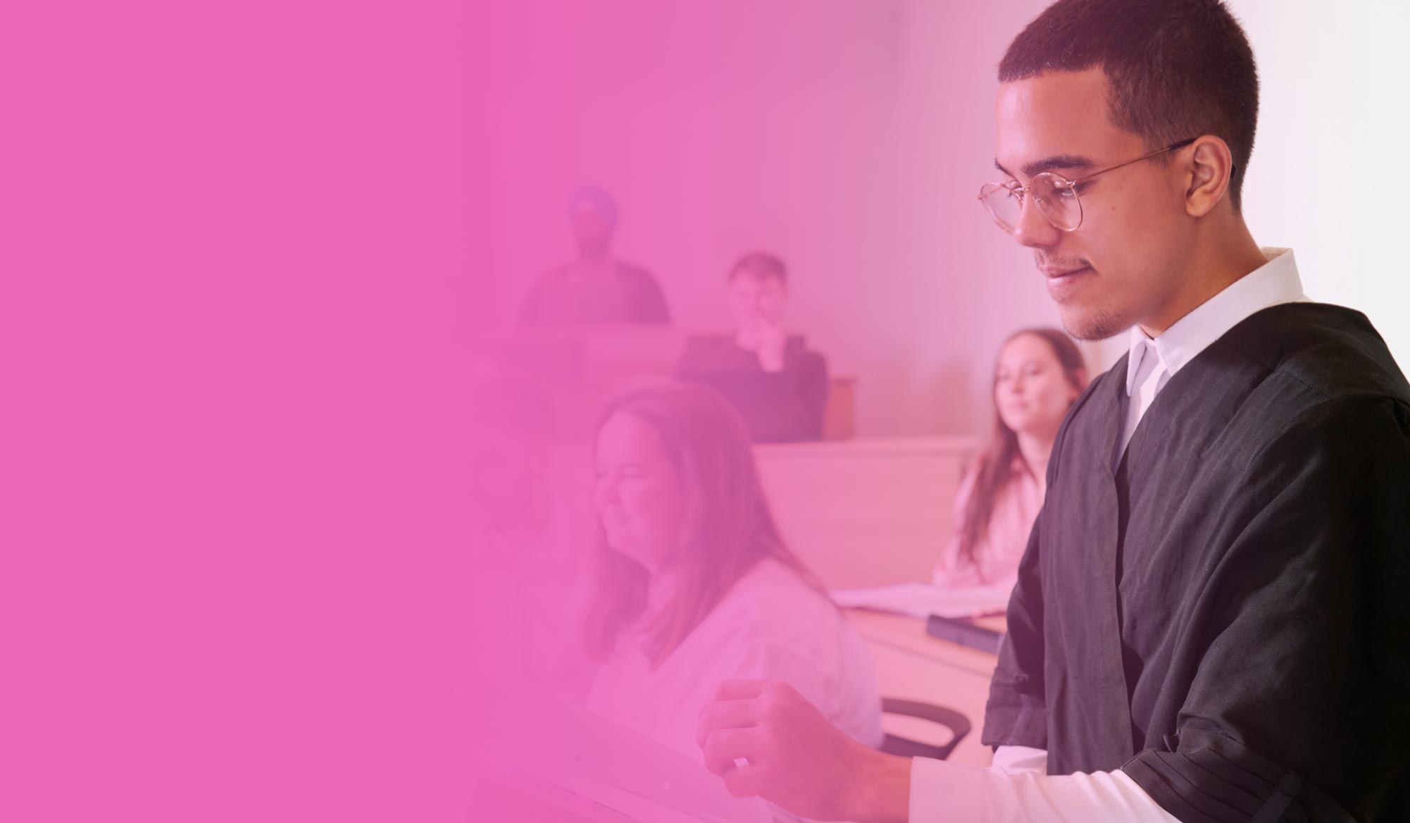 Student practising arguing a case in Sheffield Hallam's moot court, against a pink gradient background