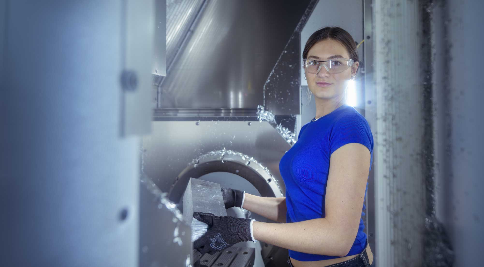 Female student stood working with engineering equipment