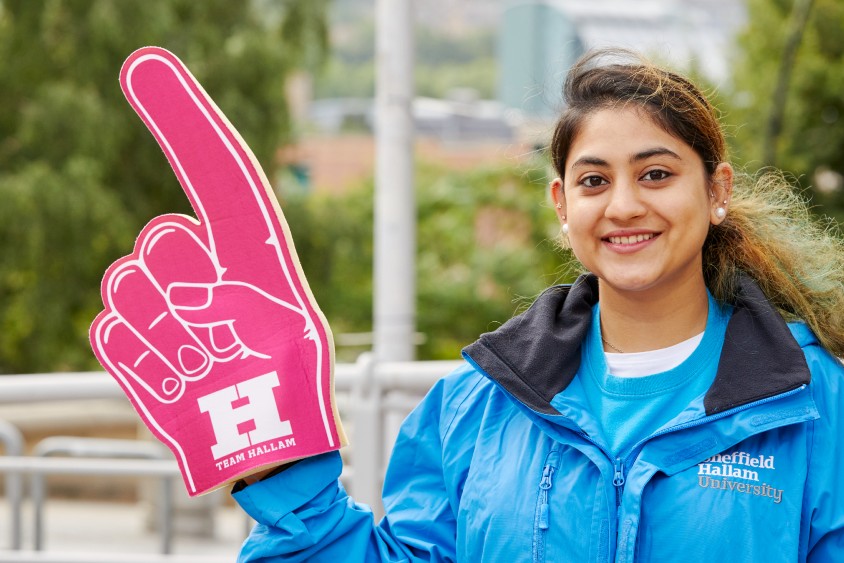 An open day ambassador holding up a Team Hallam foam finger