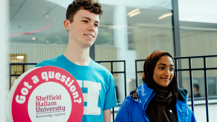 Two students working at an open day.