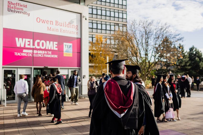 Students on graduation day outside Sheffield Hallam University Owen building 