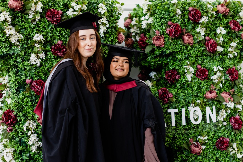Sheffield Hallam University Graduates in front of flowering Hallam H