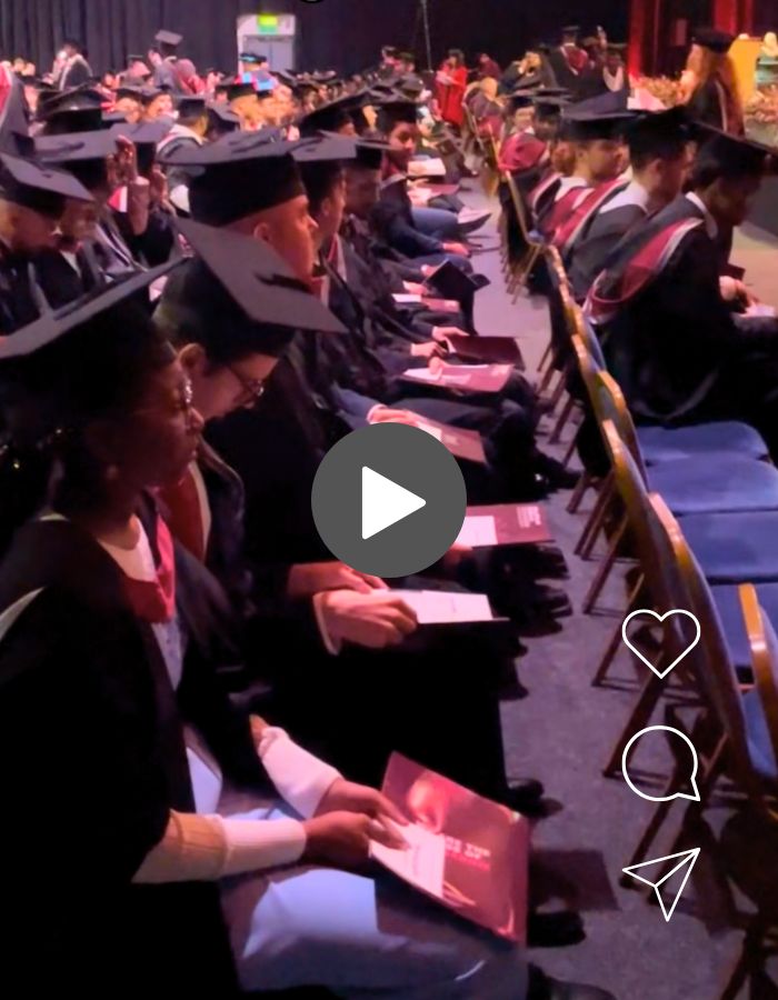 Graduates seated in a row at a graduation ceremony