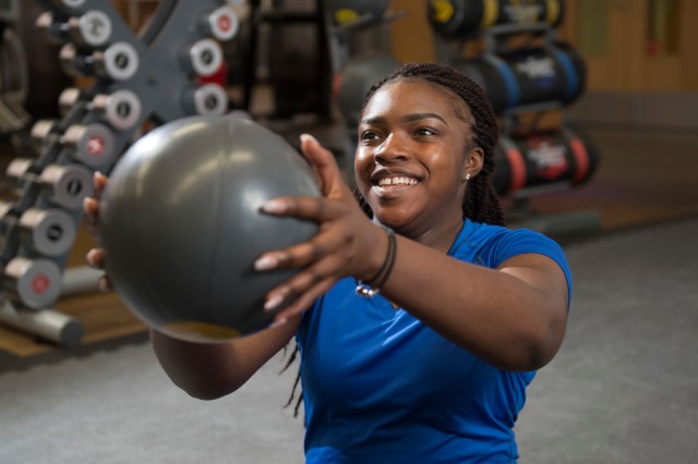 Jemima holding medicine ball in gym