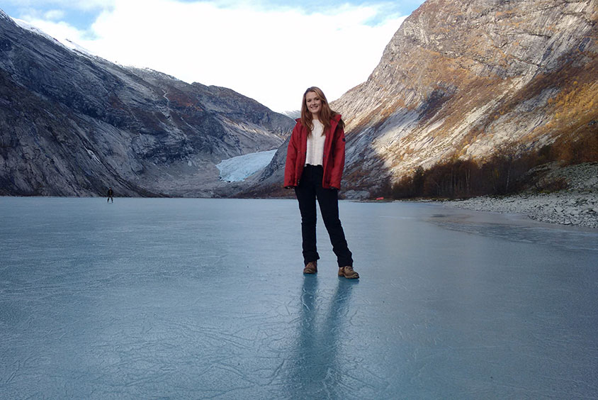 A student stood on a frozen lake in the bottom of a valley