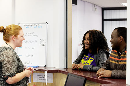 Students talking to a member of staff