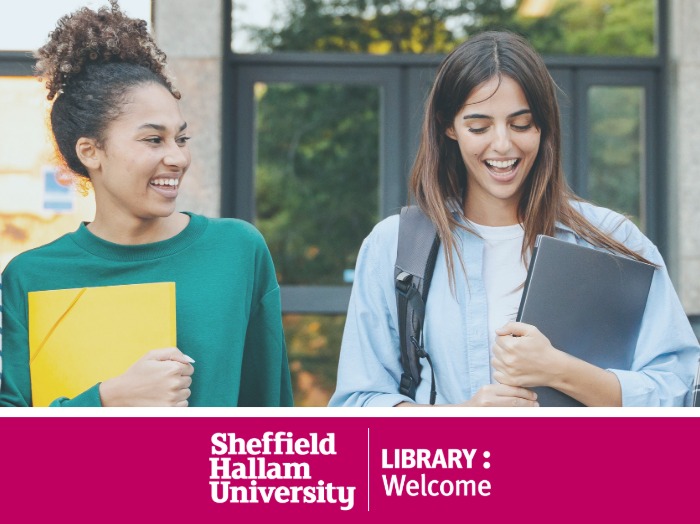 Two students, smiling, holding folders