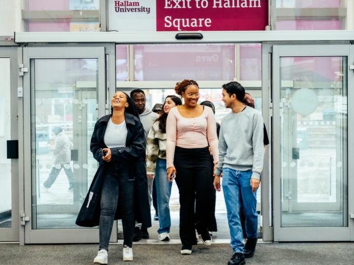 Crowd of students walking through the entrance of Owen Building