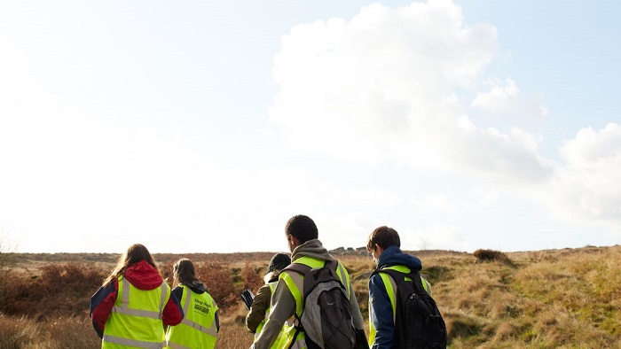 People in hi-vis jackets in nature