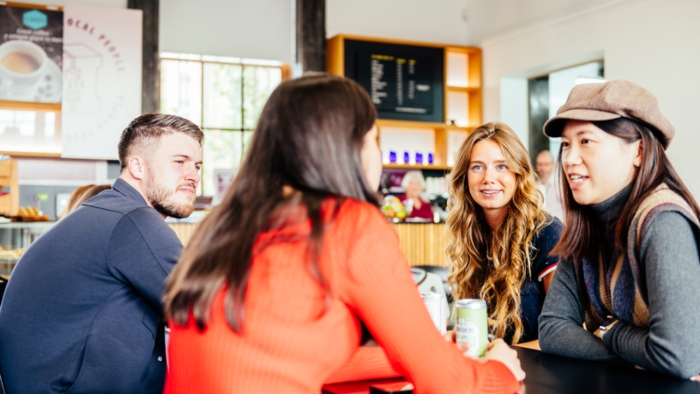 Four students sat at a café table