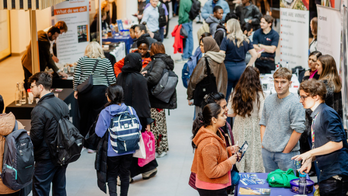 A busy hall filled with students and employers 