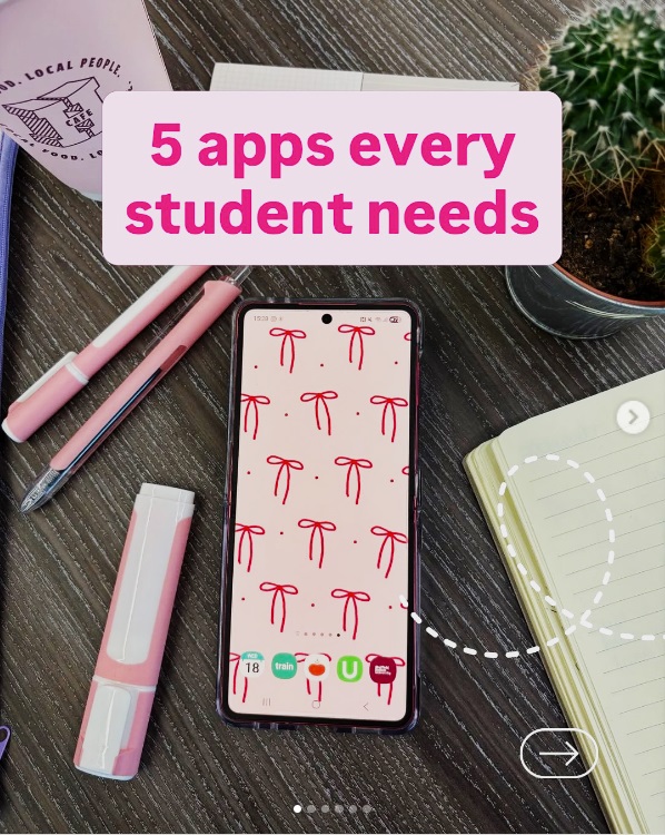 Desk with a mobile phone, highlight, pens, book, plant and disposable cup.