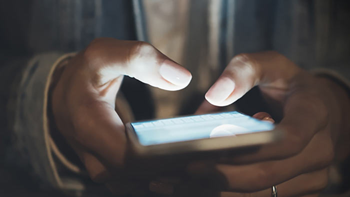 Hands using a mobile phone