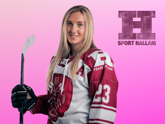 Varsity hockey player, holding her hockey stick