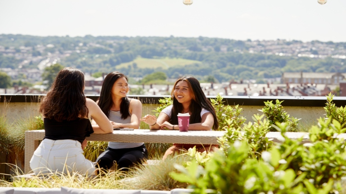 Students sitting on the LIV rooftop terrace