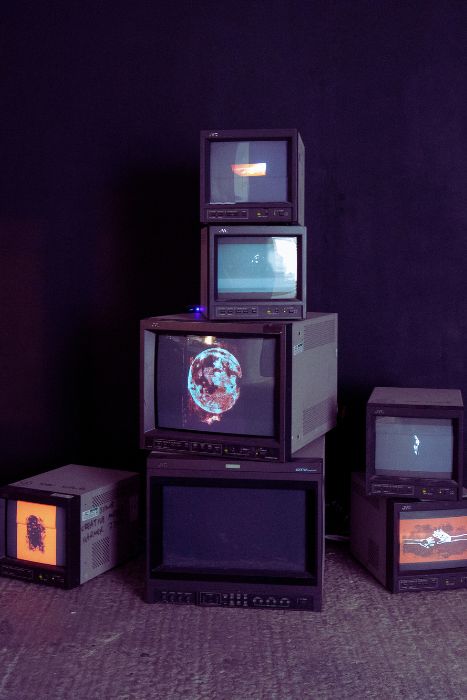 Vintage TVs stacked on top of each other as part of an exhibition piece 