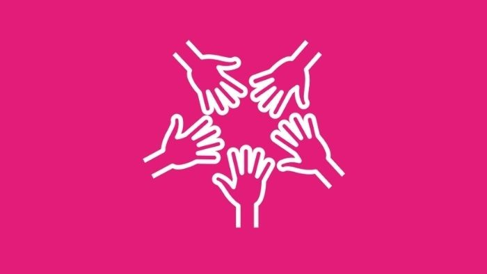 Five hands in a circle on a pink background