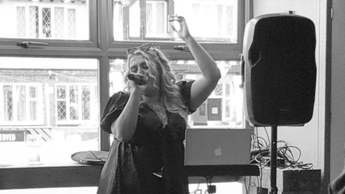 A vocalist singing in front of a crowd