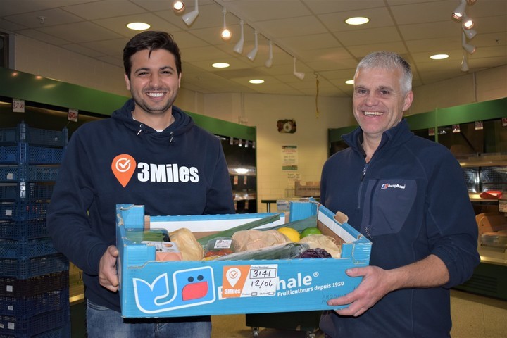 Mazen Musaeed and one of his customers with a grocery delivery from 3Miles