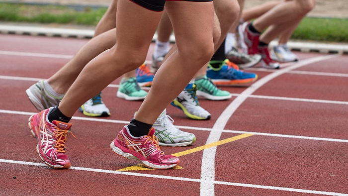 A group of runners lined up on a track waiting to set off
