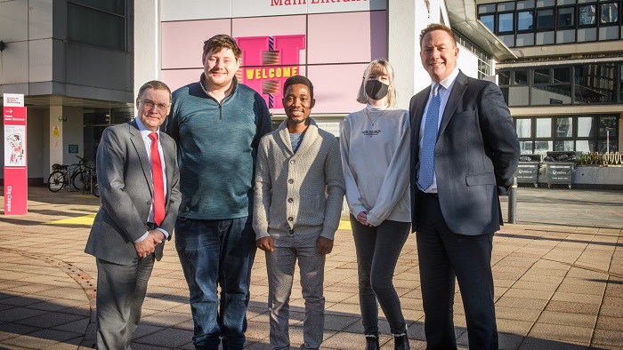 Sir Chris Husbands and three students outside Sheffield Hallam University