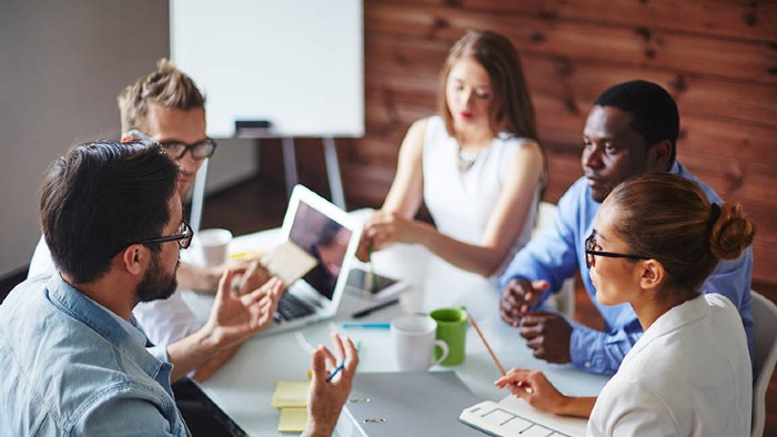 A group of young people working together in an office