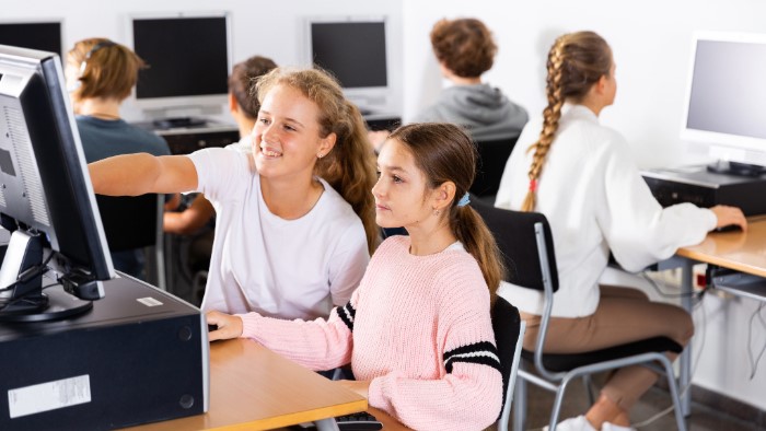 Schoolgirls on computers in a classroom