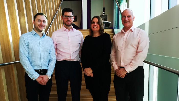 four people stood inside