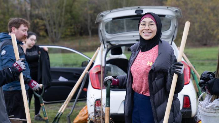 Photo of volunteer at the tree planting and conservation session smiling to camera