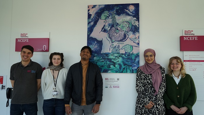Five people from NCEFE stood in front of the artwork produced for the research theme feeding a growing population