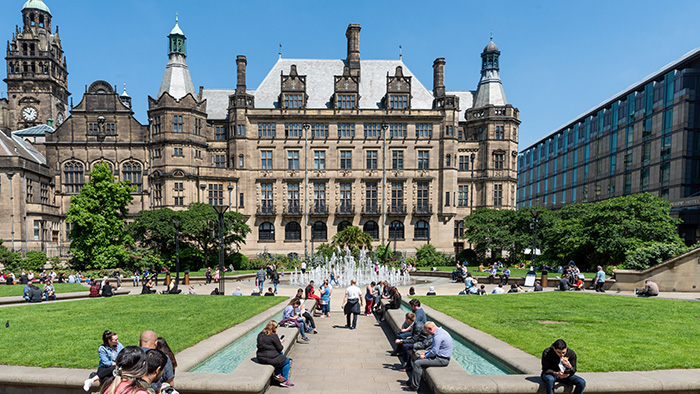 A view of Sheffield's town hall from the Peace Gardens, with fountains either side. 