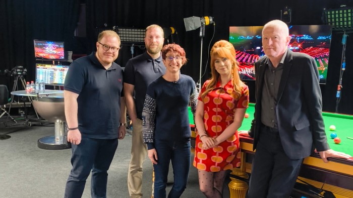 The team with six-time World Snooker Champion, Steve Davis and Presenter Abigail Davies stood in front of one the practice tables in the Crucible.