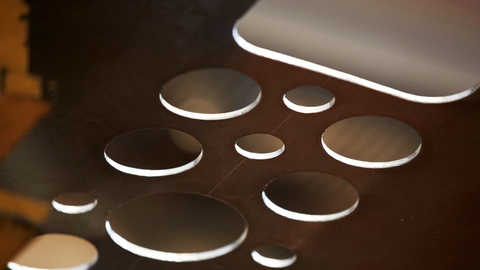 A thin sheet of metal with holes of varying size