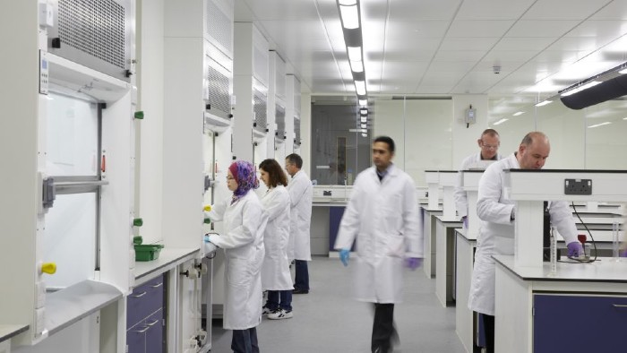 People wearing white lab coats in a science laboratory